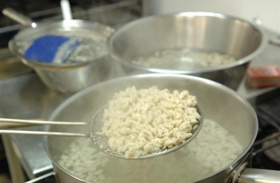 6. When the pizokel rise to the top, scoop them out with a strainer and run under cold water...