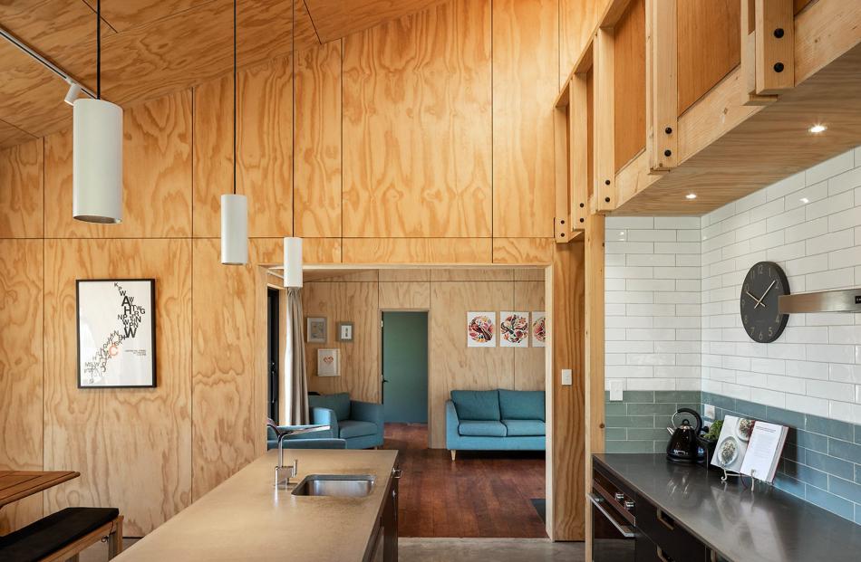 The view through the kitchen to the living area and a bedroom beyond.