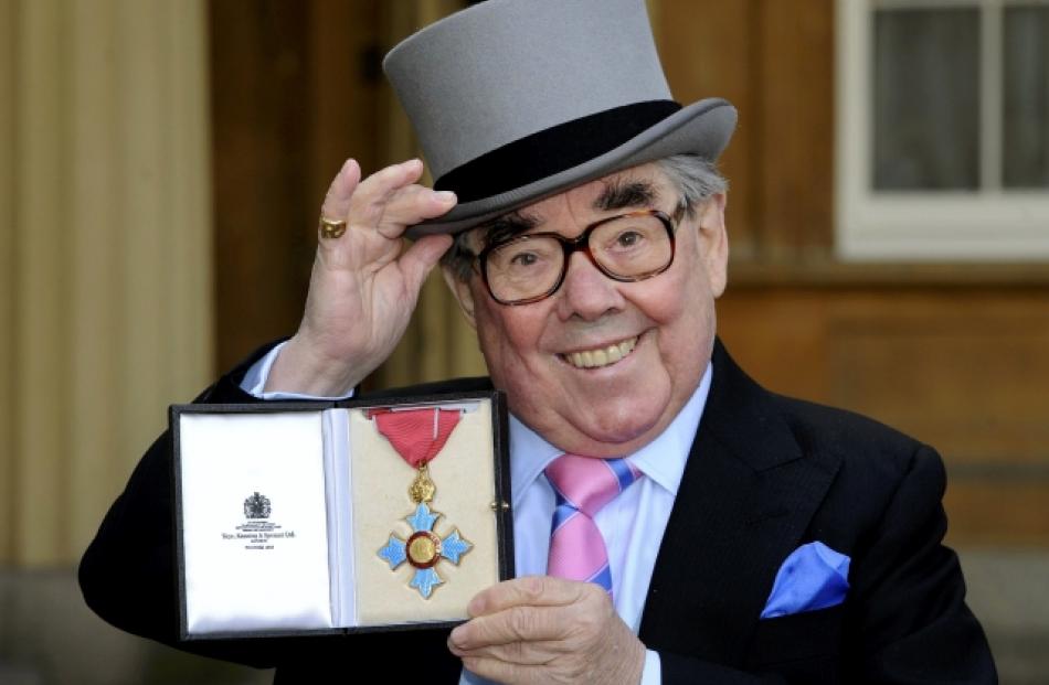 Comedian Ronnie Corbett poses for photographs after being presented with his Commander of the...