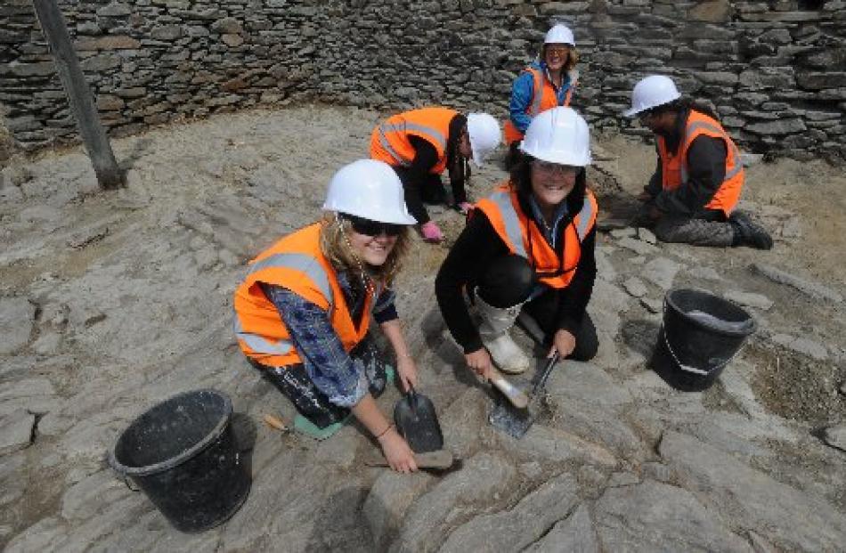 Working on the former dairy shed are (anticlockwise from front left) Sheryl McPherson, Danielle...