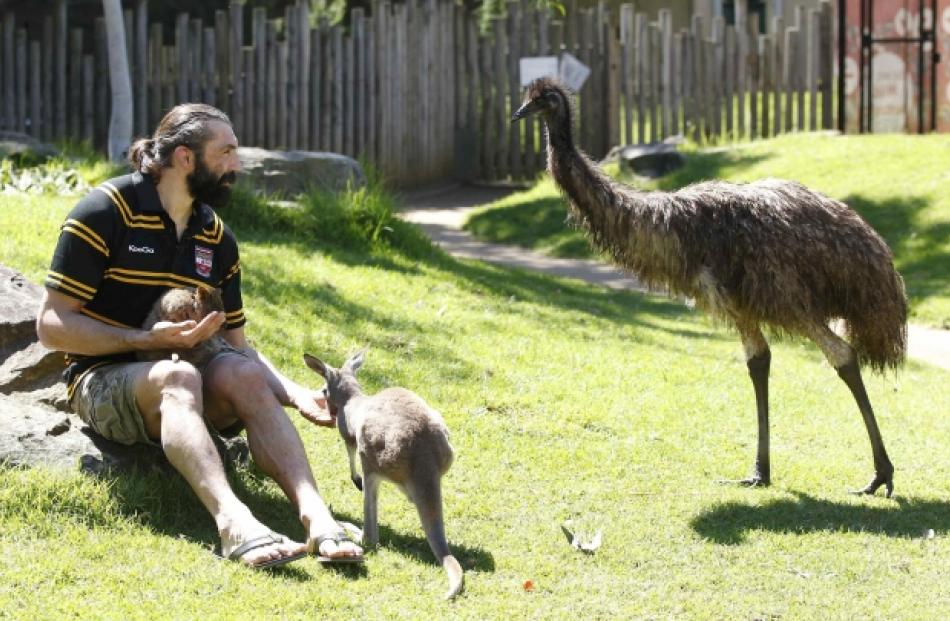 French rugby player Sebastien Chabal meets a wallaby (in his arms), a kangaroo and an emu at the...