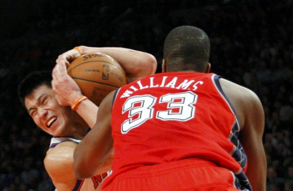 New York Knicks point guard Jeremy Lin is blocked from taking a shot by New Jersey Nets Shelden...