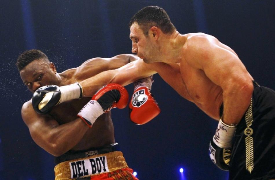 Ukrainian WBC heavyweight boxing champion Vitali Klitschko (R) lands a punch to British...