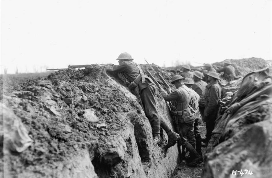 Equipment on, bayonets fixed, New Zealand troops prepare to attack at La Signy farm in France