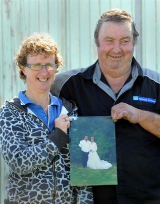 Holding a photo of  their wedding on February 29, 2000, are Tania and Tony Wilson, of Dunedin....