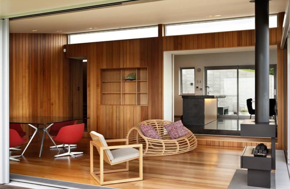 Looking into the cedar-lined summer room with the main living space and courtyard beyond.