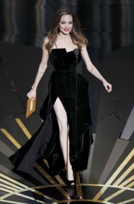 Actress Angelina Jolie walks on stage as she presents the Oscar for Best Adapted Screenplay at...