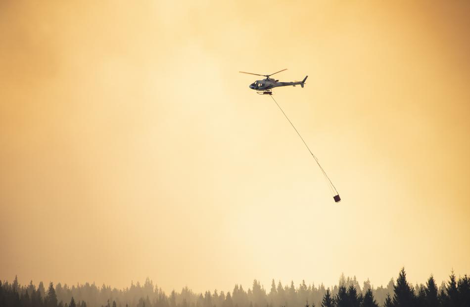 A helicopter fights the fire near Twizel. Photo: Murray Eskdale