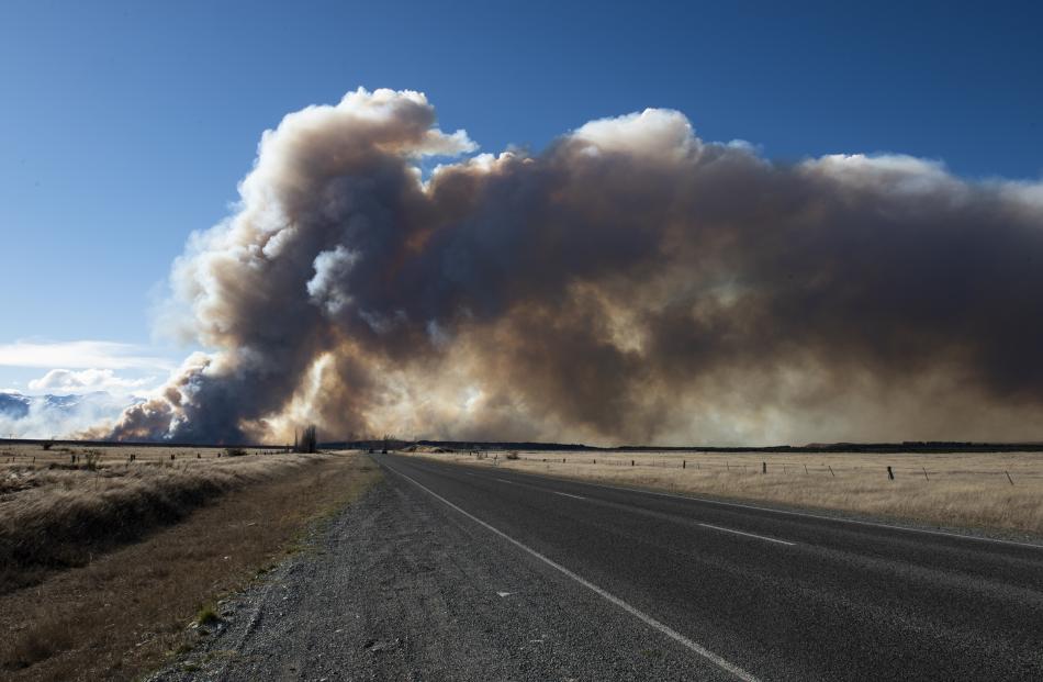 Smoke billows across the highway from the fire near Twizel. Photo: Murray Eskdale