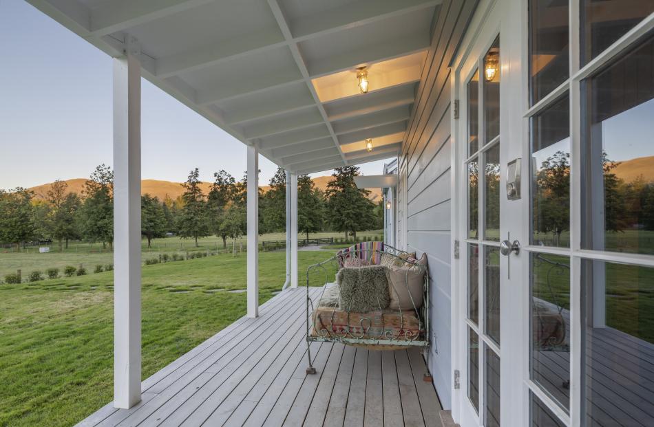 The house is on a large rural site with established trees and horses grazing in the surrounding...