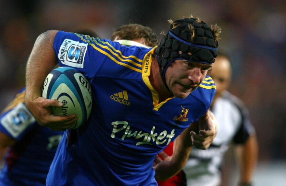 Andrew Hore of the Highlanders makes a break against the Crusaders in their Super 15 match at...