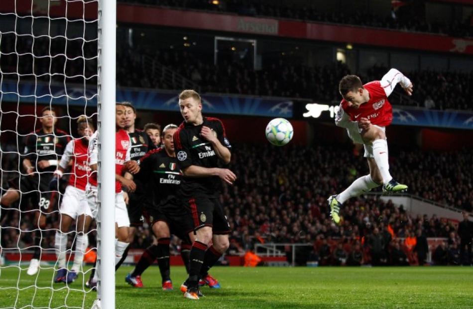 Arsenal's Laurent Koscielny scores a goal against AC Milan during their Champions League last 16...
