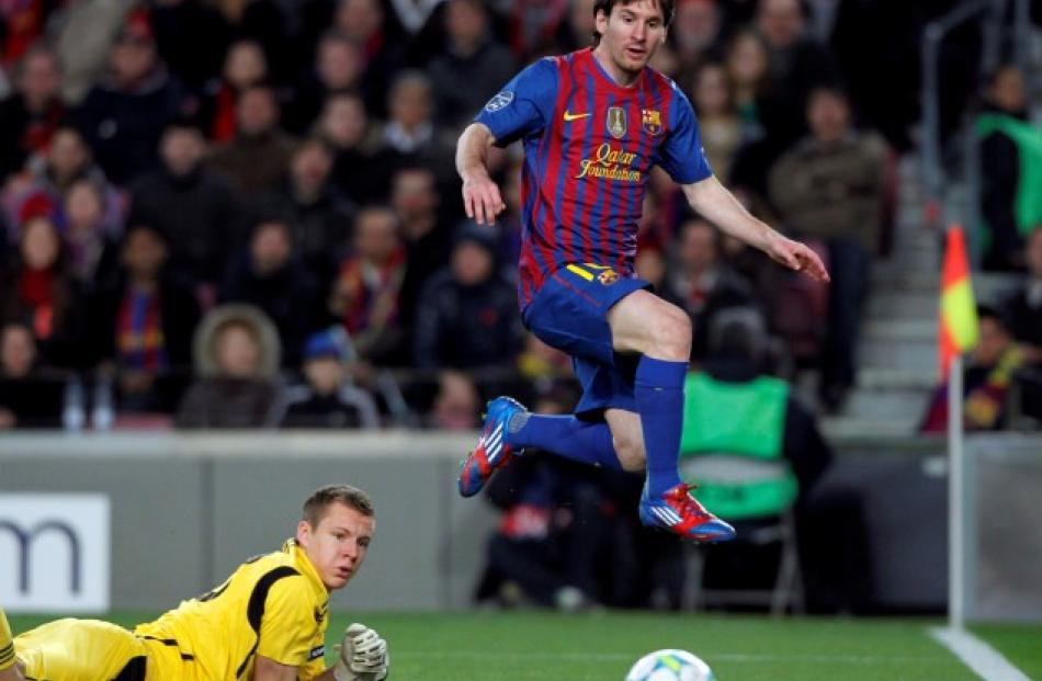 Barcelona's Lionel Messi (R) scores his fourth goal of five past Bayer Leverkusen's goalkeeper...