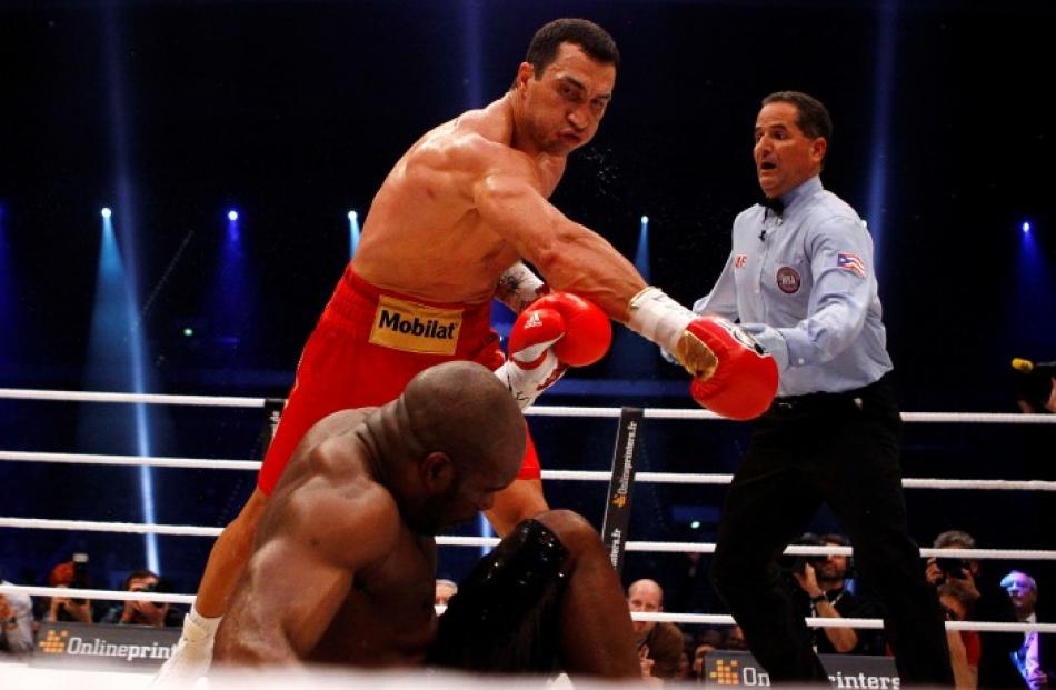 Heavyweight title-holder Vladimir Klitschko of Ukraine lands the knockout punch on Jean-Marc...