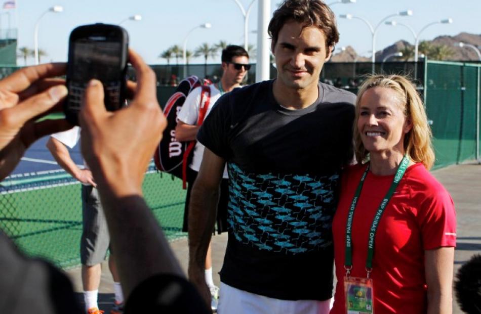 Actress Elisabeth Shue (R) poses for a photo with Roger Federer of Switzerland after meeting him...