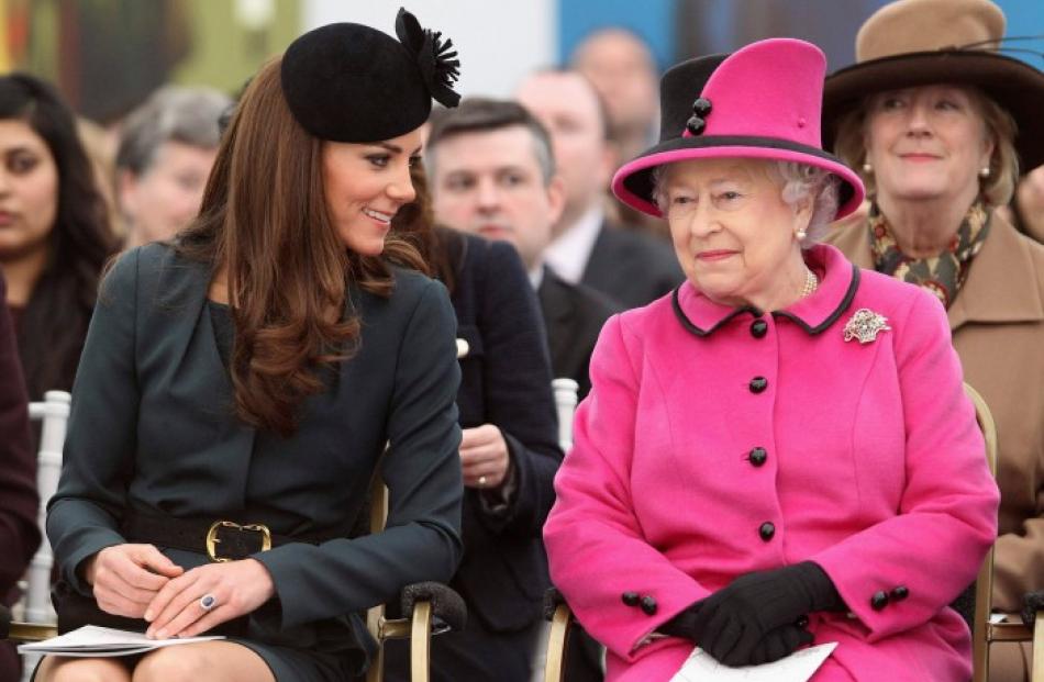 Britain's Queen Elizabeth (R) and Catherine, Duchess of Cambridge (2nd R) watch a fashion show at...