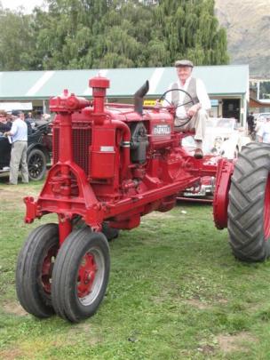 Sandy Morris drives a 1937  McCormick-Deering Farmall tractor at the 75th Upper Clutha A and P...