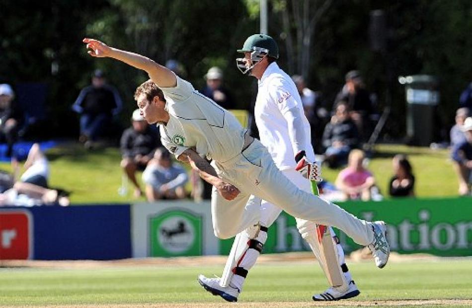 Dough Bracewell bowls while Jacques Kallis backs up. Photo by Peter McIntosh