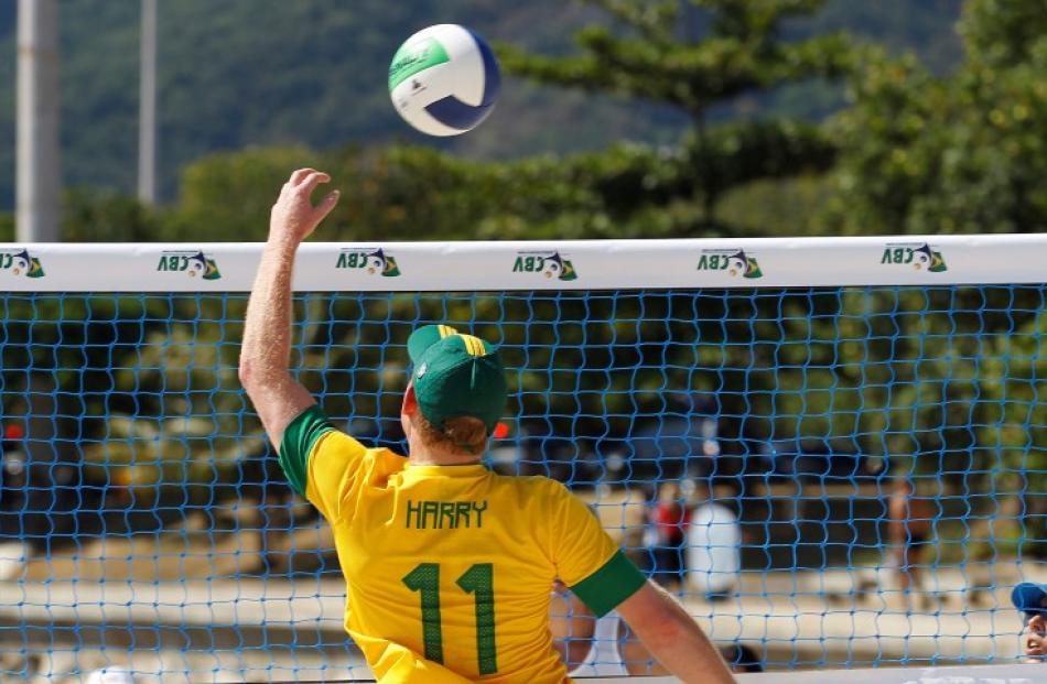 The prince participates in a beach volleyball match. REUTERS/Suzanne Plunkett