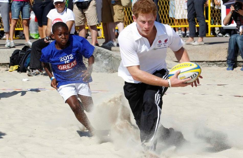 The prince plays beach rugby on Flamengo Beach in Rio De Janeiro. REUTERS/Suzanne Plunkett