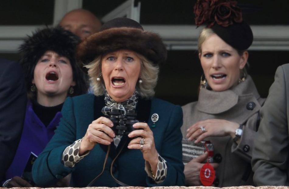 Britain's Camilla (C), Duchess of Cornwall, and Zara Phillips (R) react during The Queen Mother...