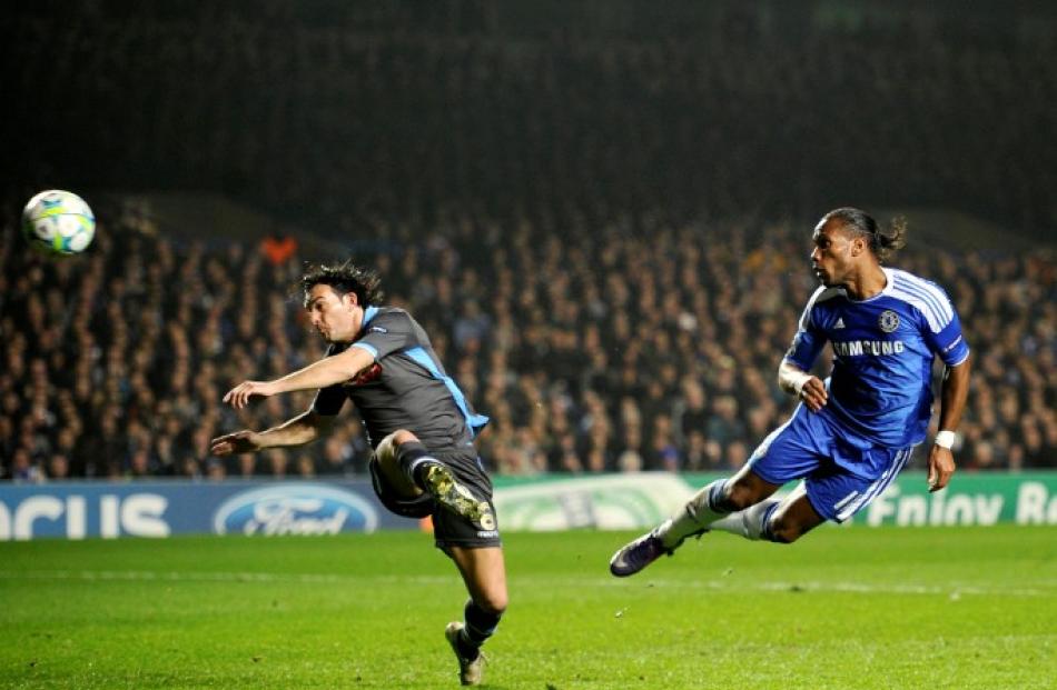 Chelsea's Didier Drogba (R) scores past Napoli's Salvatore Aronica during their Champions League...
