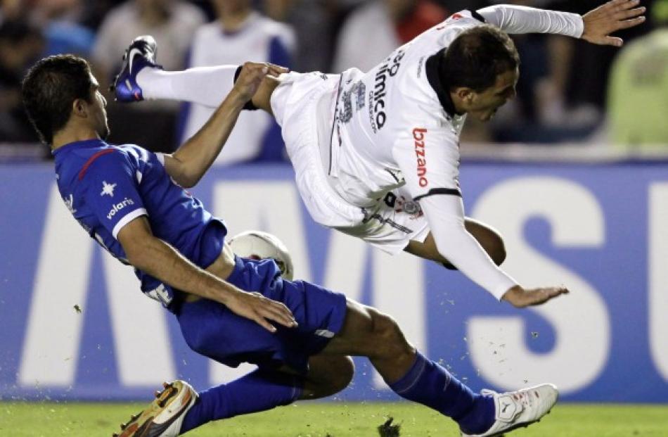 Fabio Santos (R) of Brazil's Corinthians battles for the ball against Jais Pereyra of Mexico's...