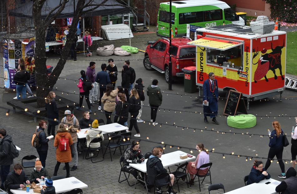 Patrons at the Food Truck Festival consider their options on the University of Otago lawn...