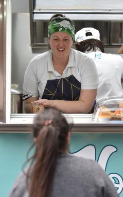 Nom Nom food truck’s Naomi Collins serves a customer.