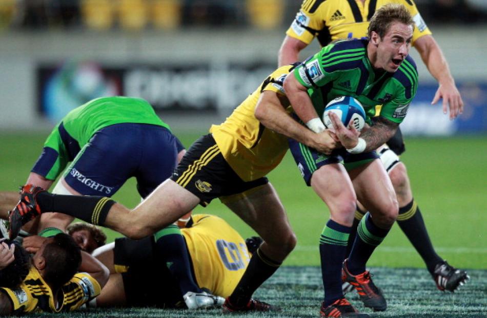 Highlanders halfback Jimmy Cowan looks to clear the ball.  (Photo by Hagen Hopkins/Getty Images)