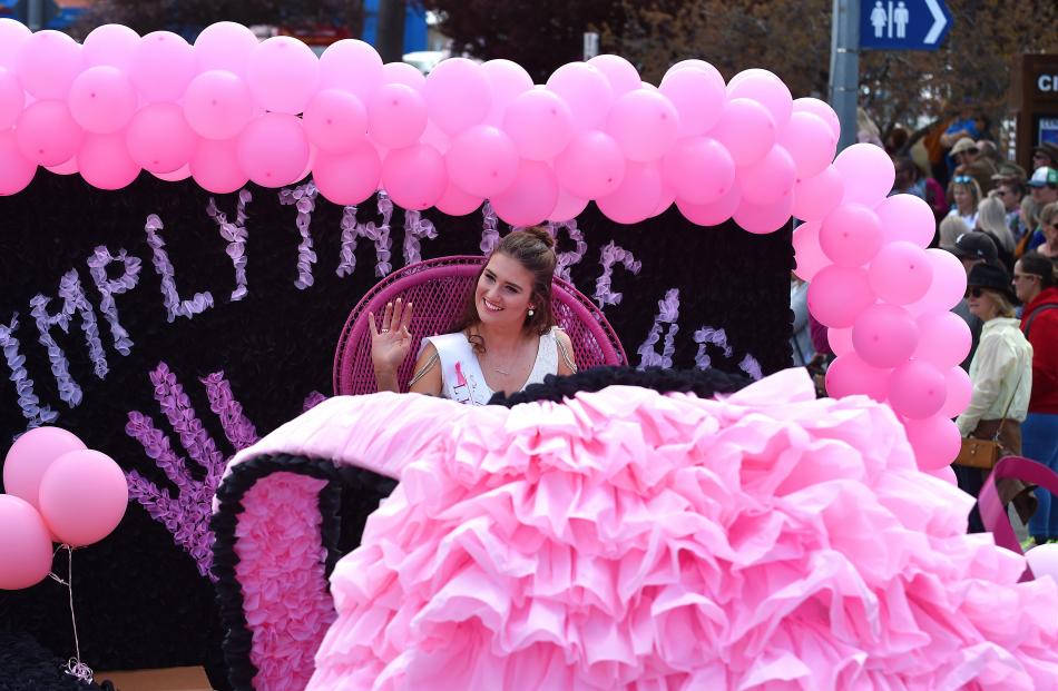 Blossom Festival Princess Celia Ward waves from the LJ Hooker Breast Cancer Awareness float.
