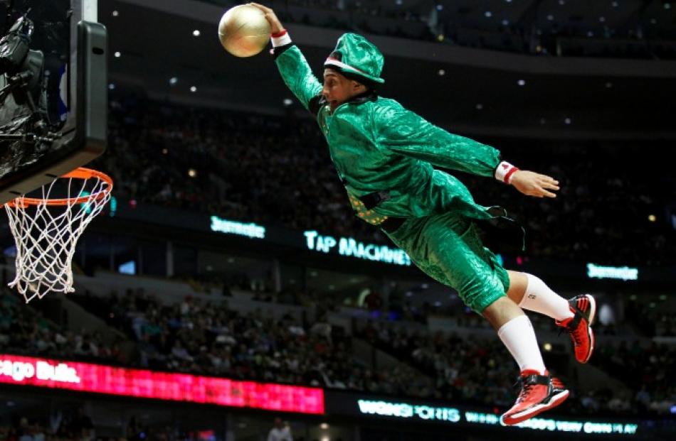 A member of the 'Benny and the Elevators' acrobatic team, dressed in a leprechaun outfit for St....