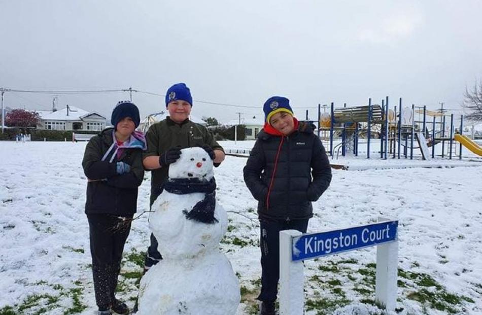 Lennox Beer, Vann Adams and Kalel Beer made a snowman at Moore Park in Milton. Photo: Jussy Beer-Williams