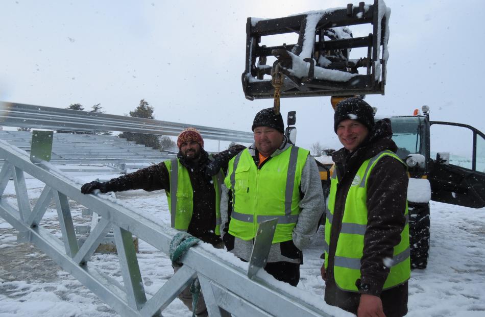 Jono McDonald, Nathan McDermott and Brayden Holden of Nathan McDermott Building Ltd work through the cold and falling snow to erect the steel framework for the roof of the new coolstore being built at T & G's Ettrick site. Photo: Yvonne O'Hara