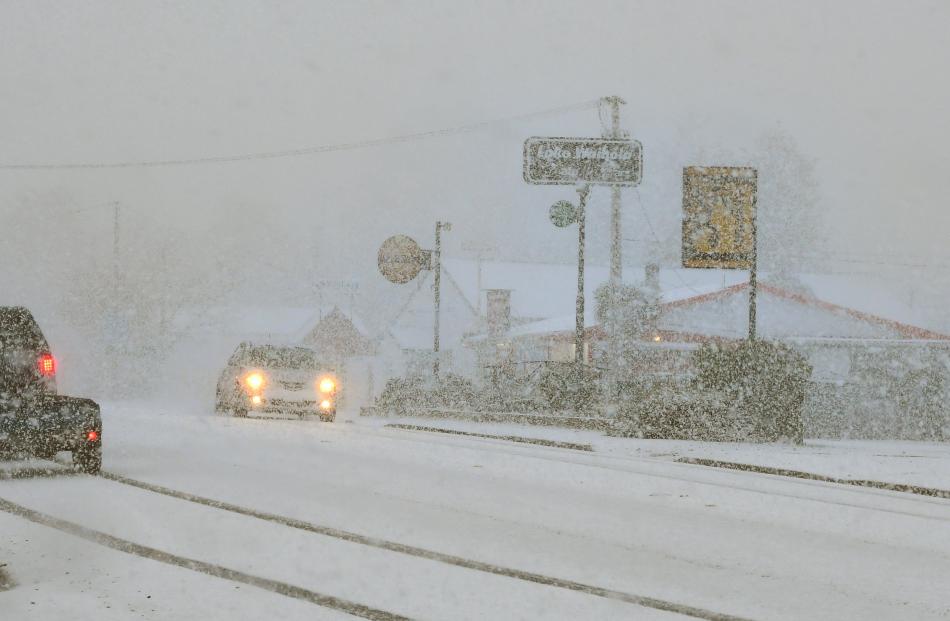 Traffic crawls through blizzard-like conditions in Waihola.