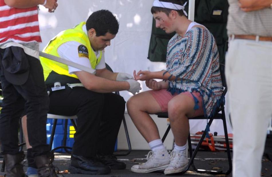 A St John staff member administers first aid to a  party-goer.