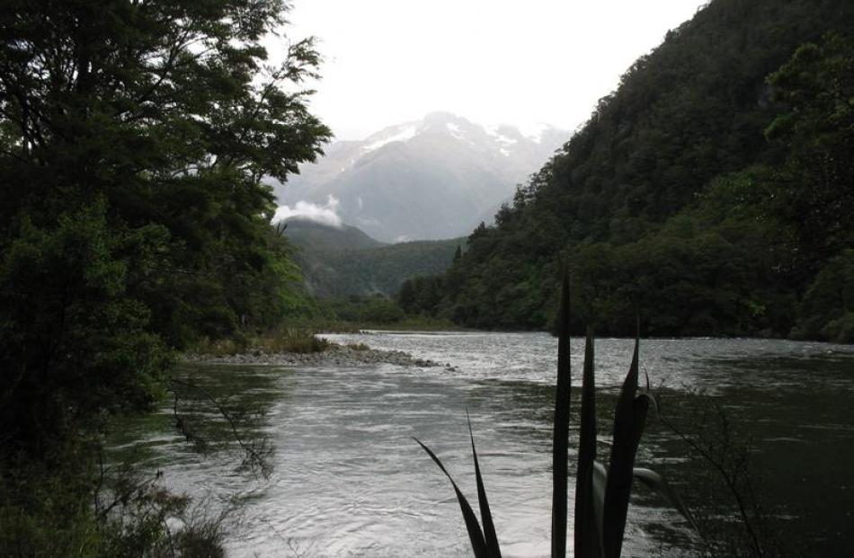 Mist rises to reveal the Darran Mountains over the Pyke River.