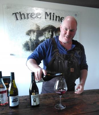 Paul Wright from Three Miners pours a glass of pinot noir.