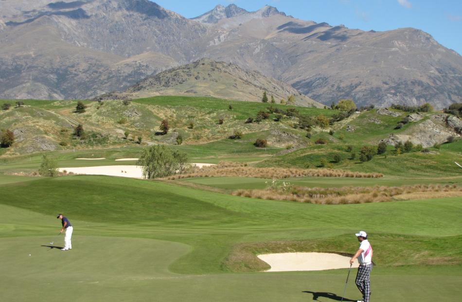 Golfers  play the 15th hole during the first day of the 2012 NZPGA Pro-Am at The Hills, Arrowtown...