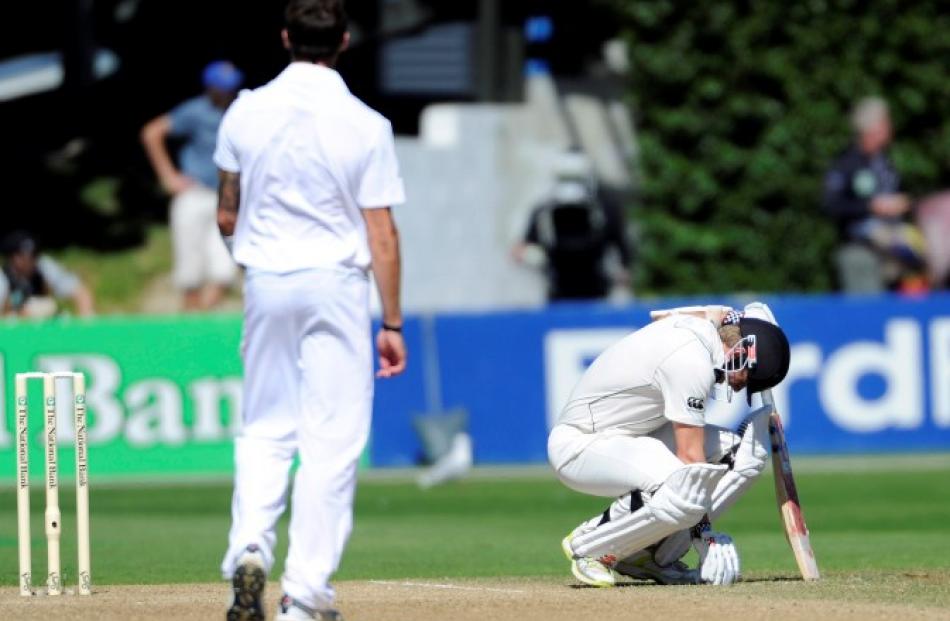 New Zealand's Kane Williamson reacts to being hit in the groin by a ball from South Africa's Dale...