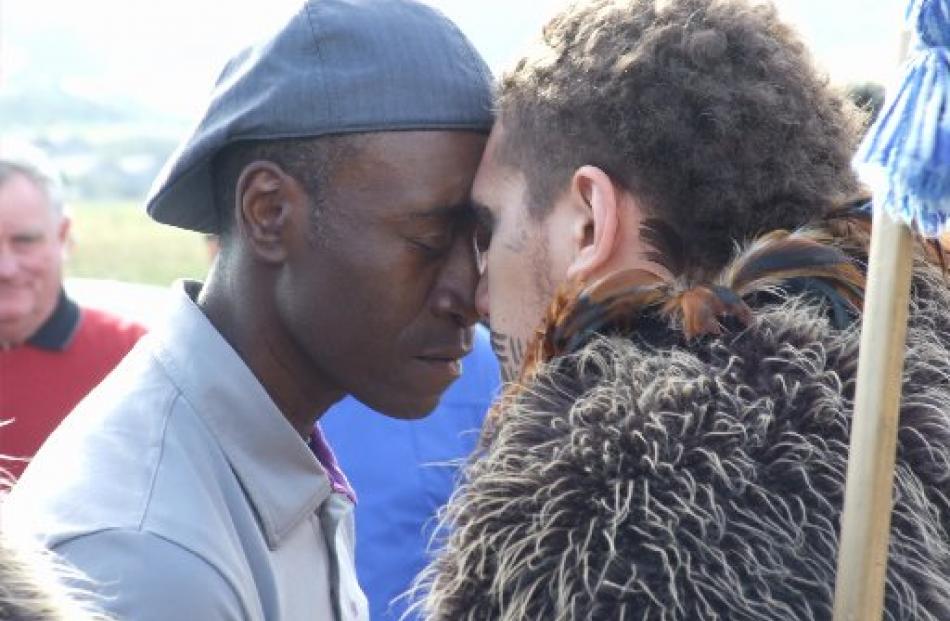 Hollywood actor Don Cheadle performs a hongi with a member of  Queenstown's Kiwi Haka group on...