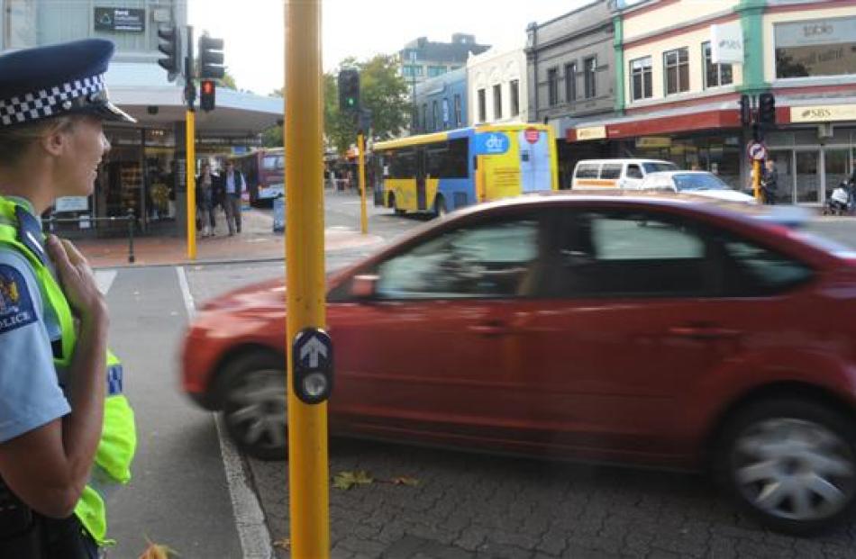 Police officers check on traffic and motorists' behaviour yesterday at Hanover and George Sts...