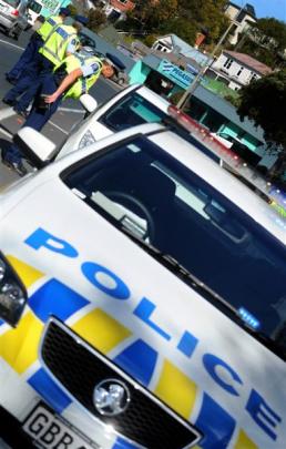 Police officers check on traffic and motorists' behaviour yesterday on Princes St by the Oval.