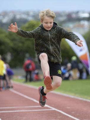 Zaydan Reynolds (8) soars in the long jump.