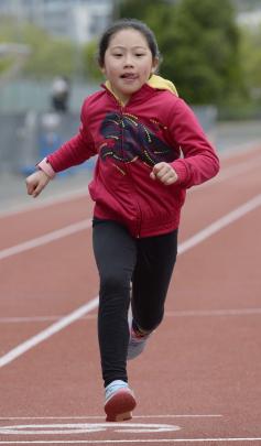 Siyao Zhu (8) sprints across the finish line.