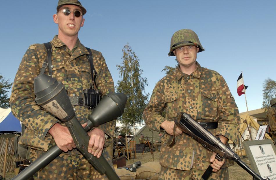 A pair of stern German army re-enactment enthusiasts  and their weapons at Warbirds over Wanaka...