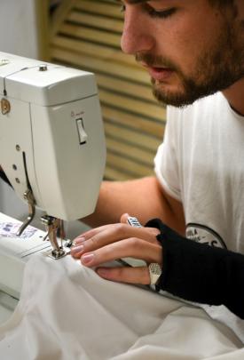 Richie Boyens sews on his Bernina 801 sewing machine at Above Ground. Photo: Emily Cannan