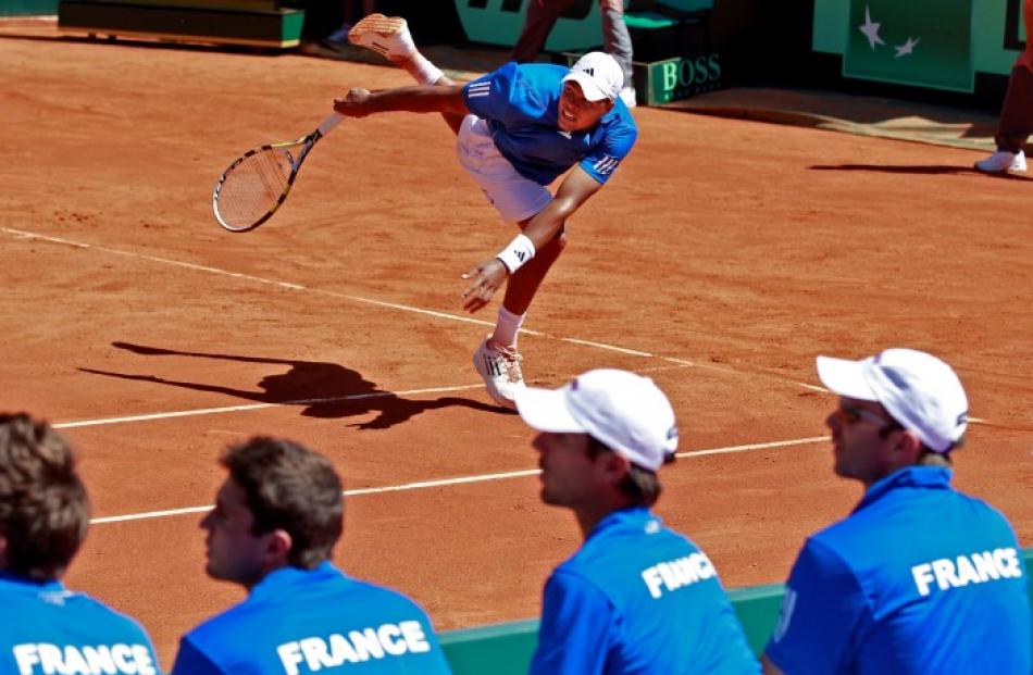 France's Jo-Wilfried Tsonga returns the ball to John Isner of the US during their Davis Cup...