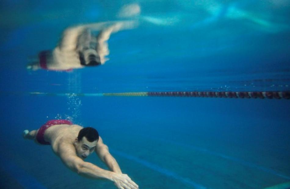 Hungarian swimmer Laszlo Cseh swims underwater during a training session in Budapest April 12,...