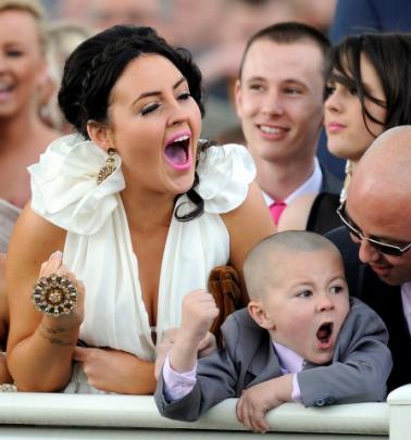 Racegoers cheer on their selections on the second day of the Grand National meeting at Aintree,...